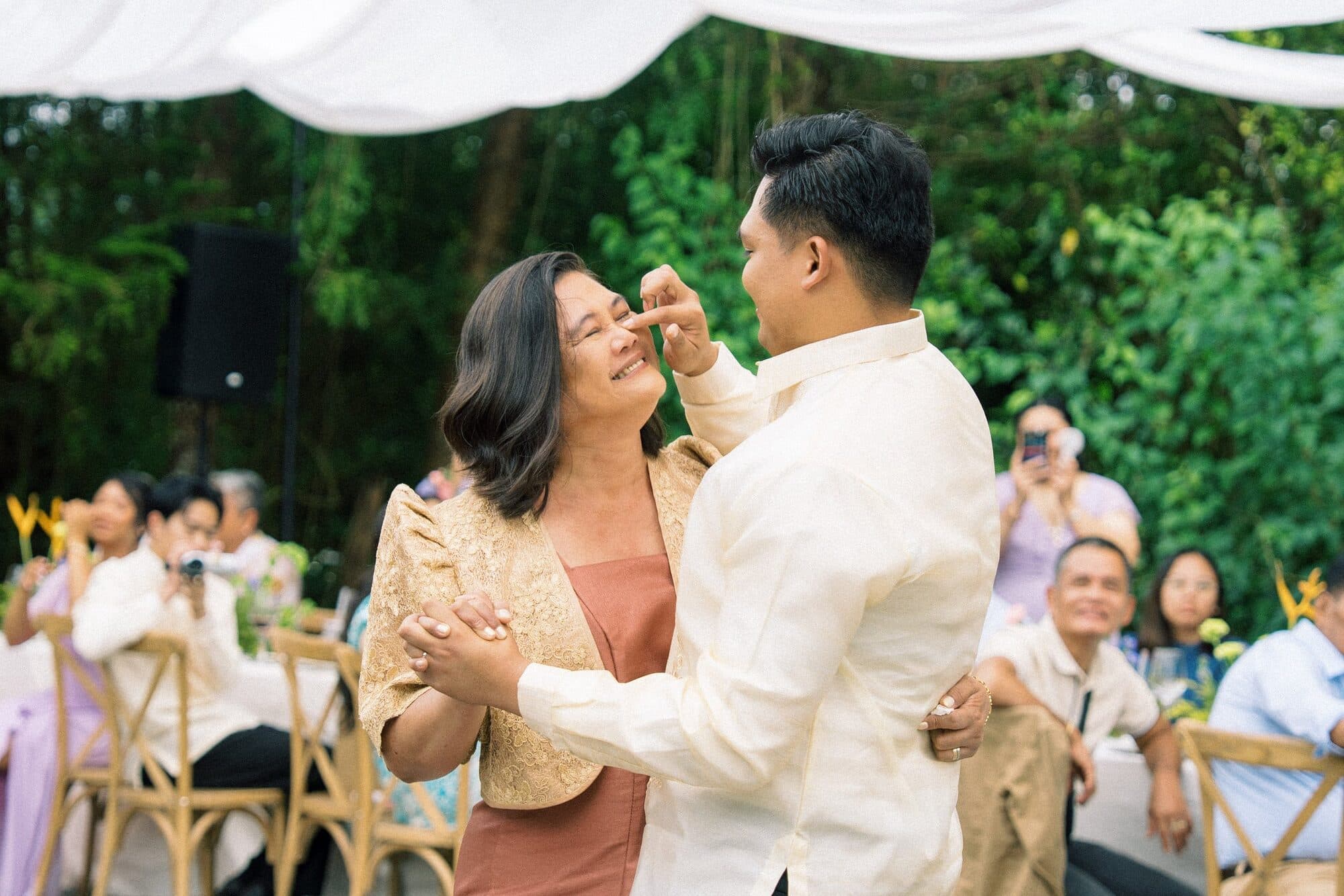 The groom dancing with his mother, turning her under his raised hand