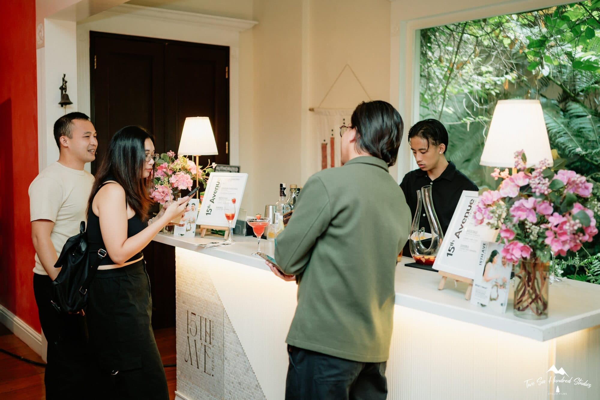 Guests gathered at the 15th Avenue mobile bar, its counter dressed with flowers and menu cards