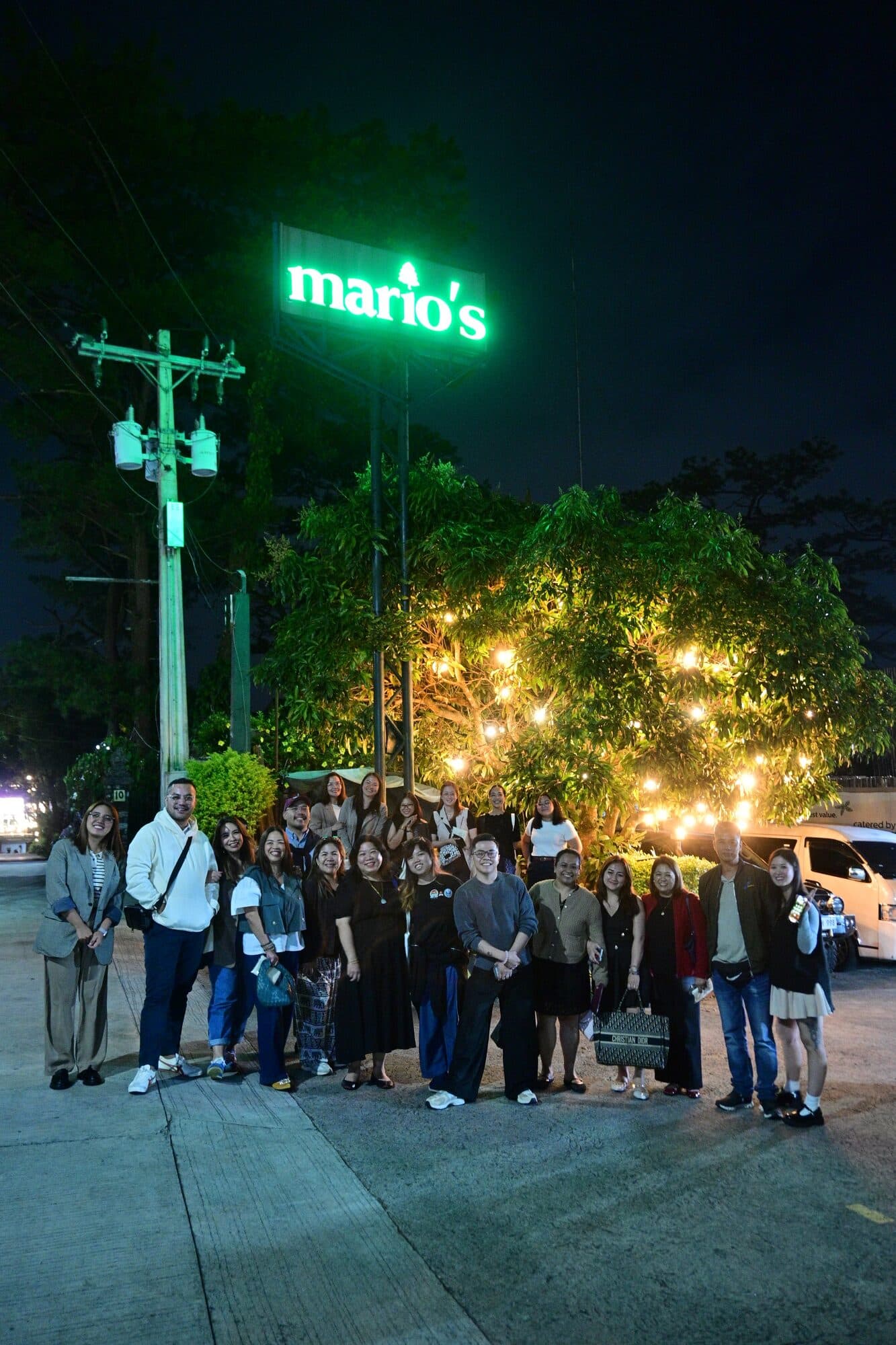 The group gathered outside under the glowing green Mario’s sign at the end of the night