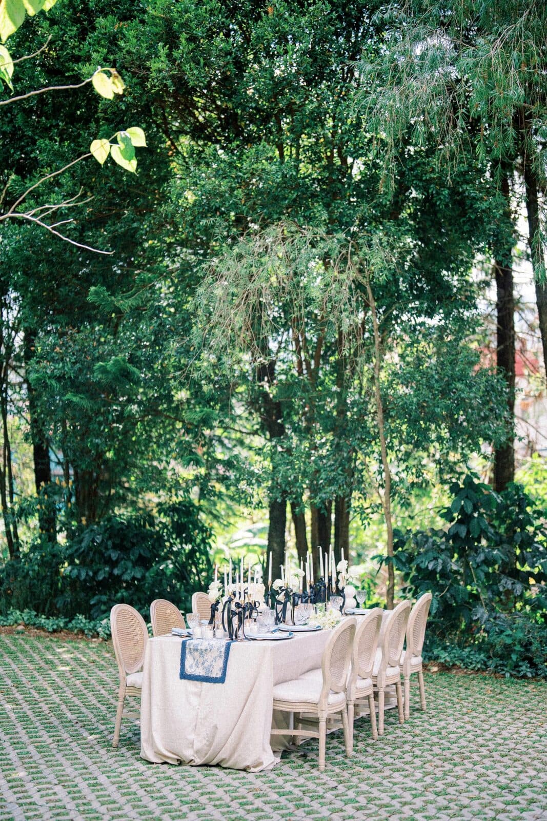 An outdoor reception set among the trees at dusk